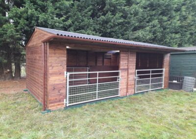 7.2m x 3.6m mobile shelter on steel skids. Half mesh gates on the front and also a hinged gate inside acting as a optional dividing partition.